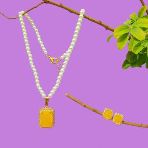 white pearl necklace set with yellow stone pendant and earrings