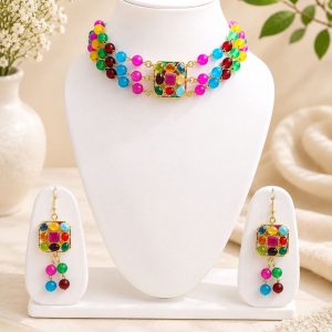 Multicolor beaded necklace set displayed on jewellery stand with matching earrings