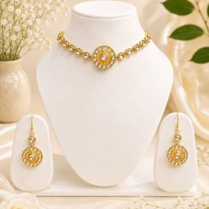Gold plated Kundan necklace set displayed on jewellery stand with matching earrings