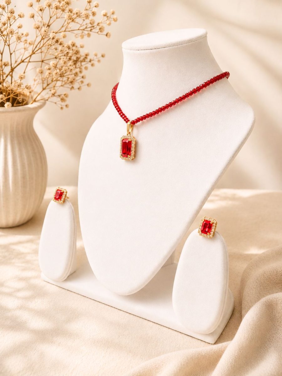 Gold plated red crystal pendant necklace with matching earrings