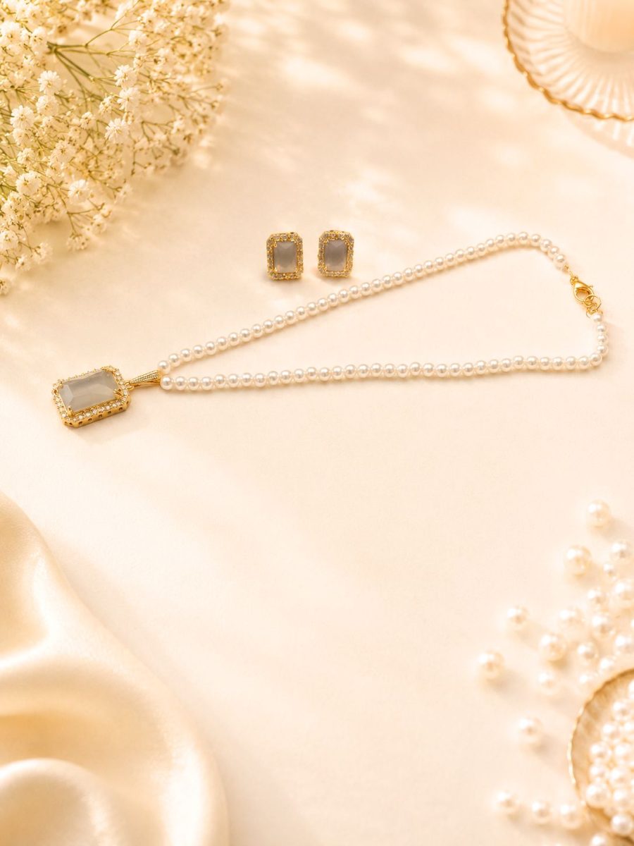Elegant white stone pendant necklace set with matching earrings