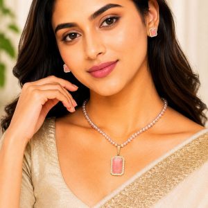 Woman wearing pink crystal pearl pendant necklace set with matching stud earrings