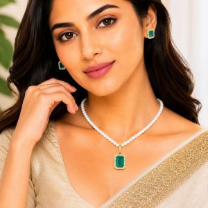 Woman wearing green crystal pearl pendant necklace set with matching stud earrings