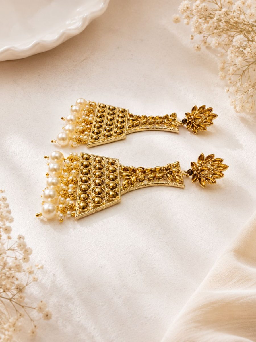 Side view of gold plated pearl jhumka earrings for women