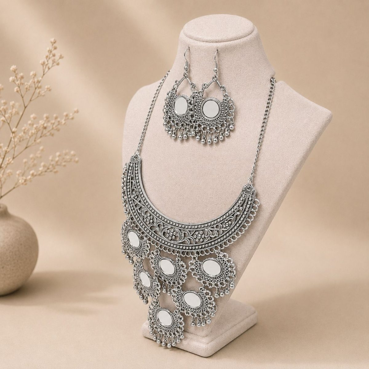 mirror necklace set with earrings on stand side view