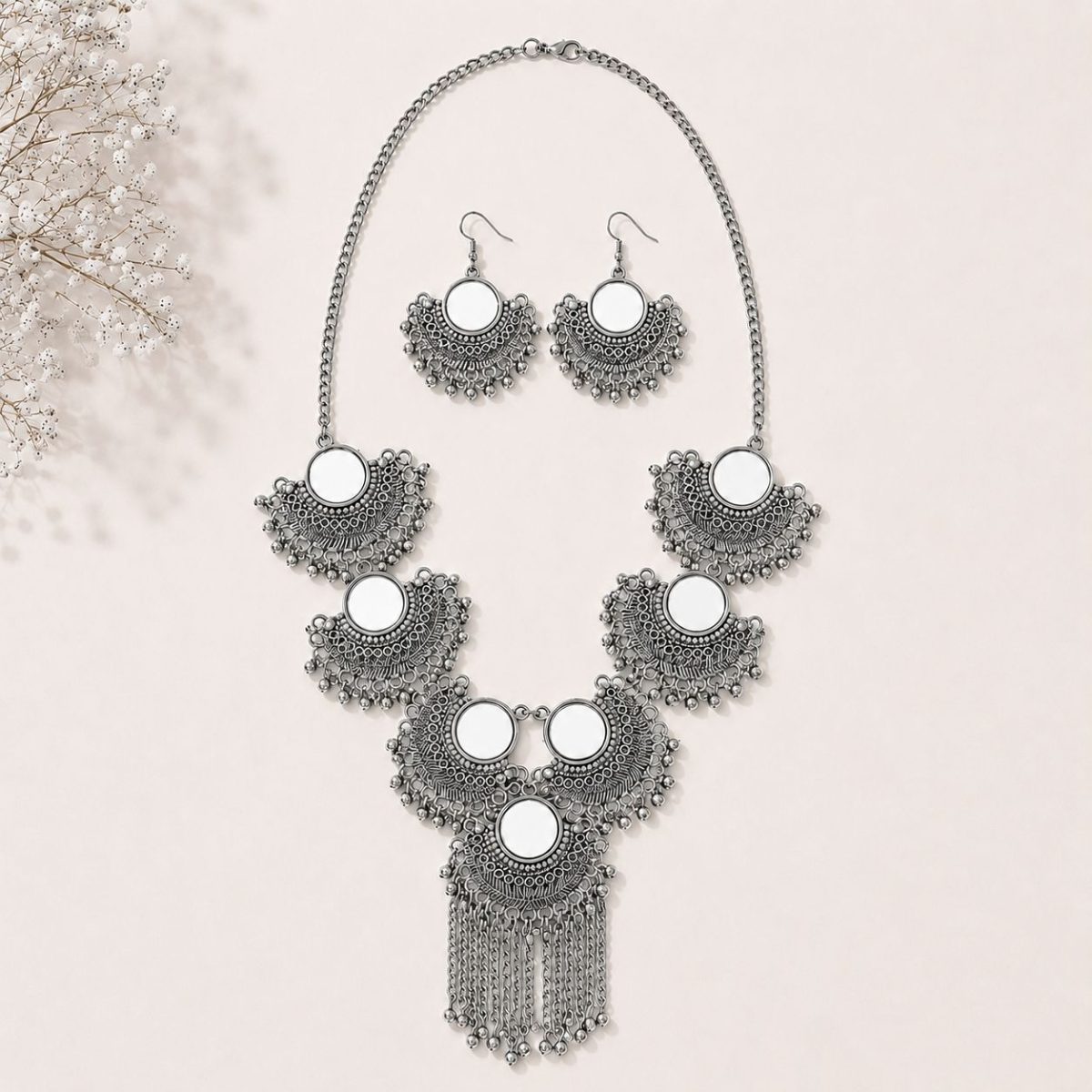 mirror necklace set on flat surface
