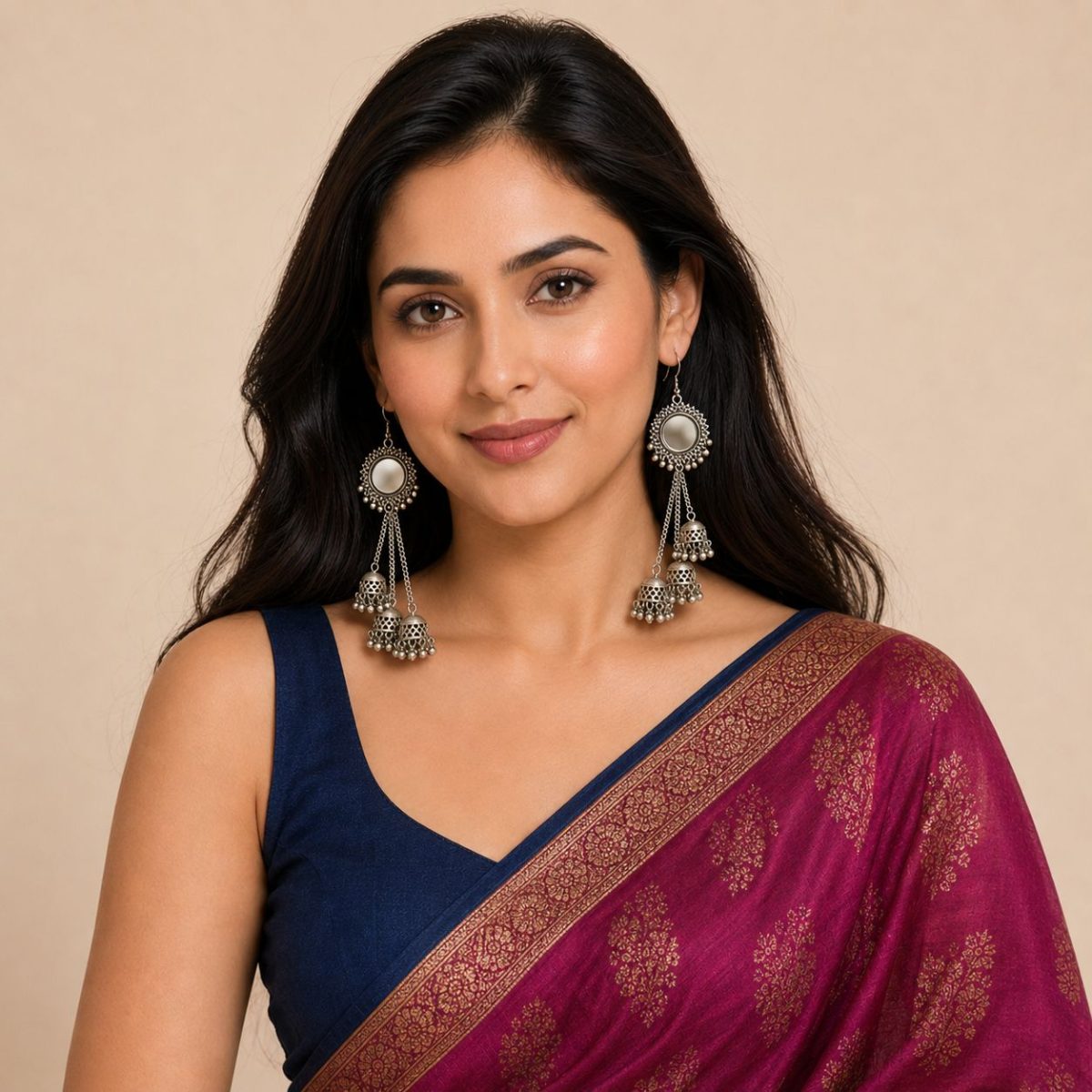 Woman wearing oxidised mirror jhumka earrings with chain tassel design